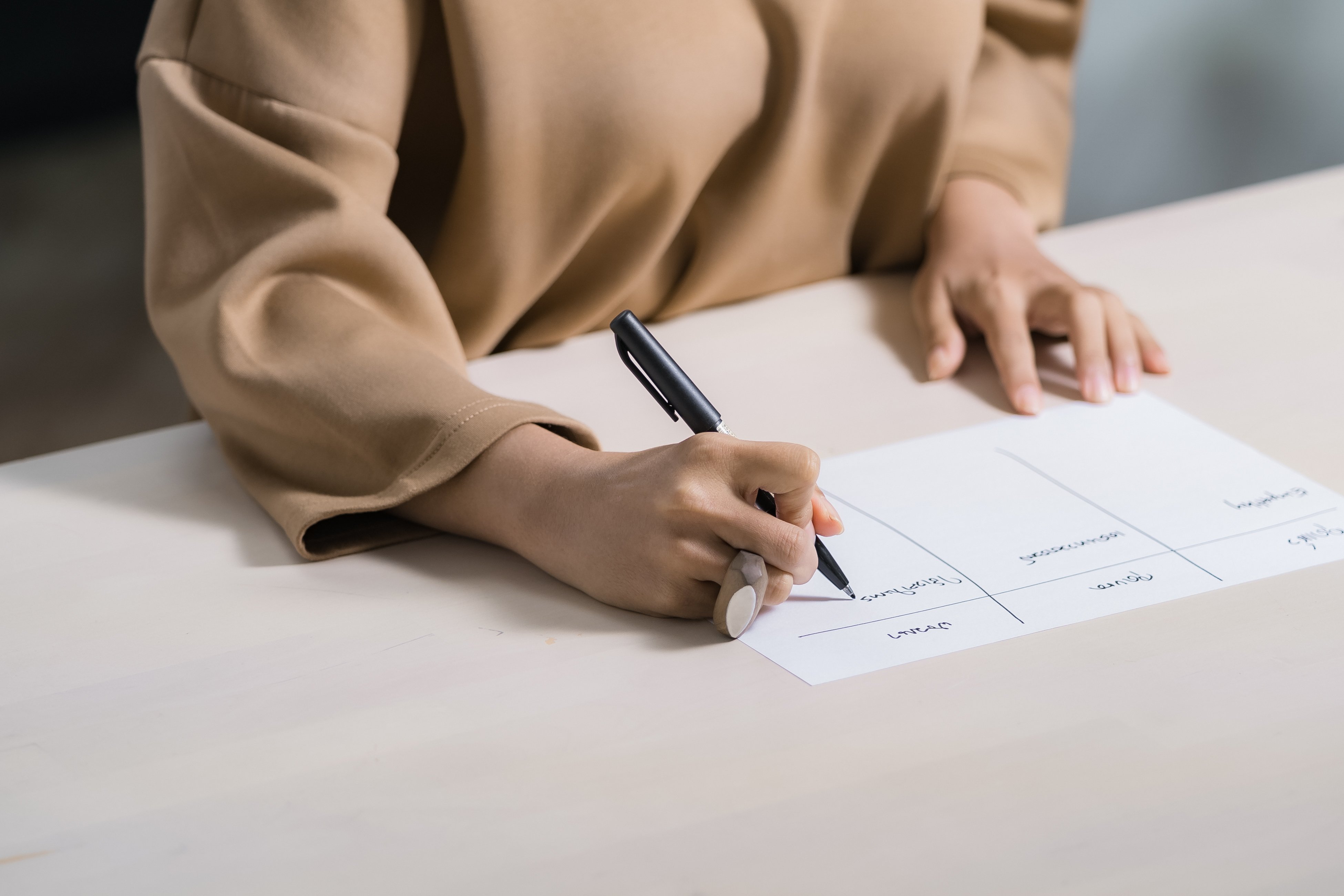 Person writing at desk